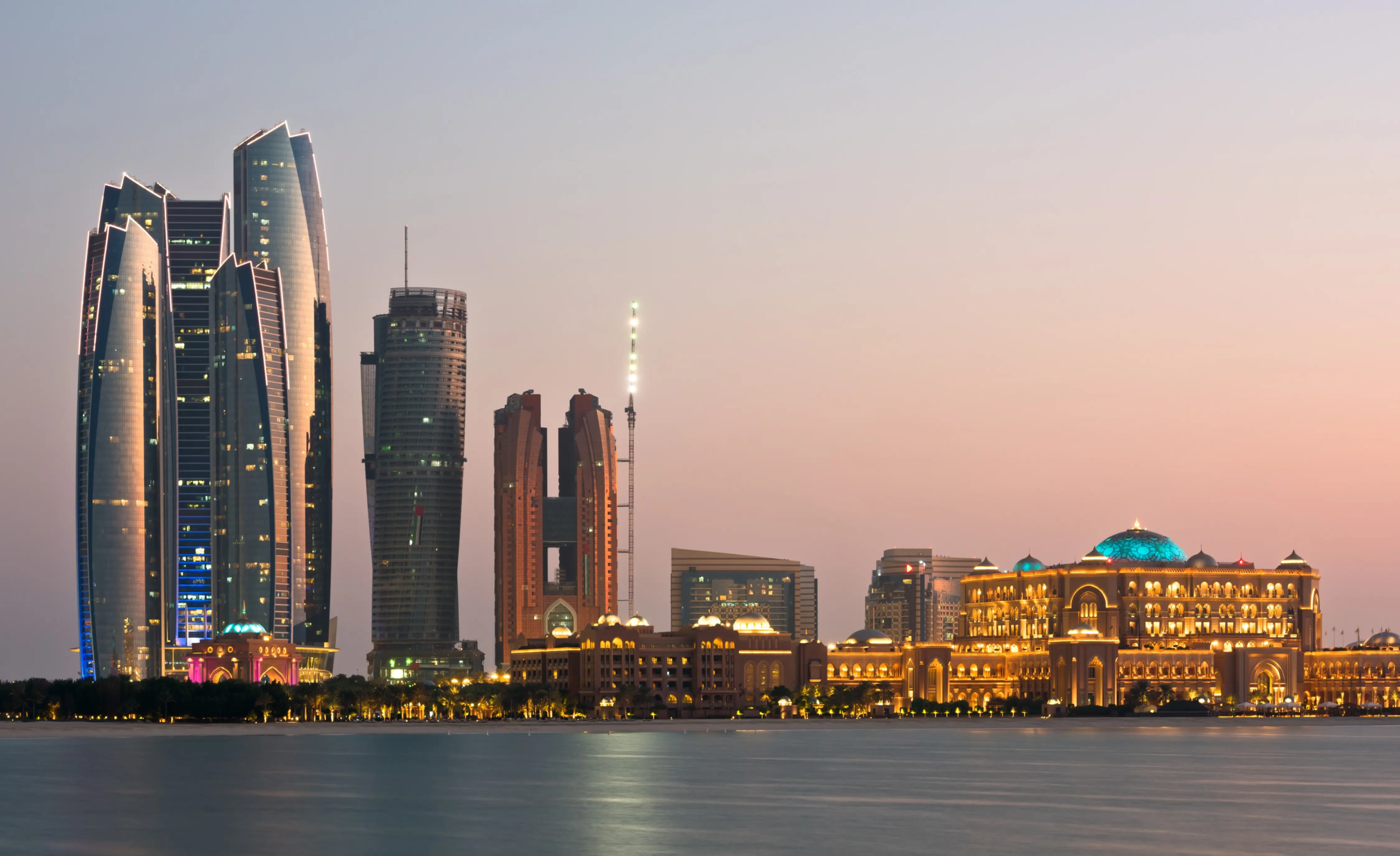professional real estate consultant in abu dhabi Modern skyline at sunset over water